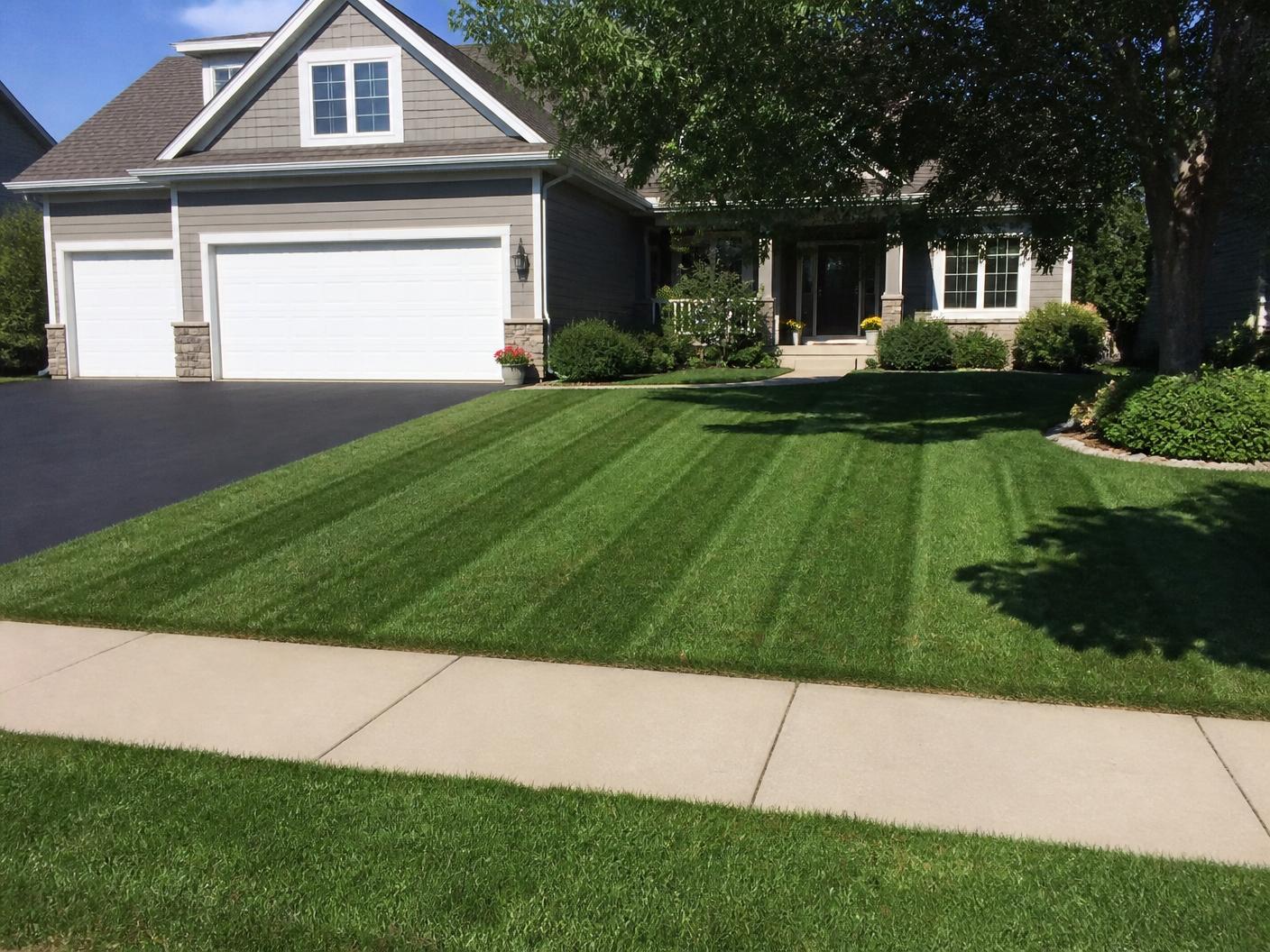 Freshly mowed and edged front lawn at a Minnesota family home